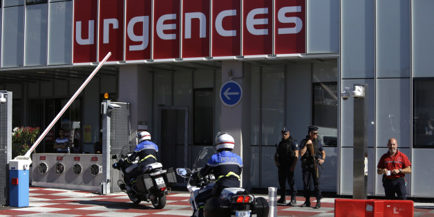 Riot olice officers and gendarmes are pictured outside the Pasteur Hospital in Nice, southern France, Friday July 15, 2016. A large truck plowed through revelers gathered for Bastille Day fireworks in Nice, killing more than 80 people and sending others fleeing into the sea as it bore down for more than a mile along the Riviera city's famed waterfront promenade. (AP Photo/Claude Paris)