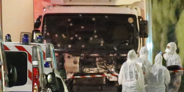 French police forces and forensic officers stand next to a truck July 15, 2016 that ran into a crowd celebrating the Bastille Day national holiday on the Promenade des Anglais killing at least 60 people in Nice, France, July 14. REUTERS/Eric Gaillard