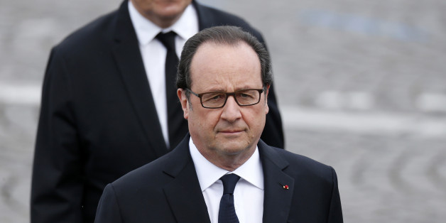 French President Francois Hollande and French Defence Minister Jean-Yves Le Drian attend the Bastille Day military parade on the Champs-Elysees in Paris, France, July 14, 2016. REUTERS/Benoit Tessier