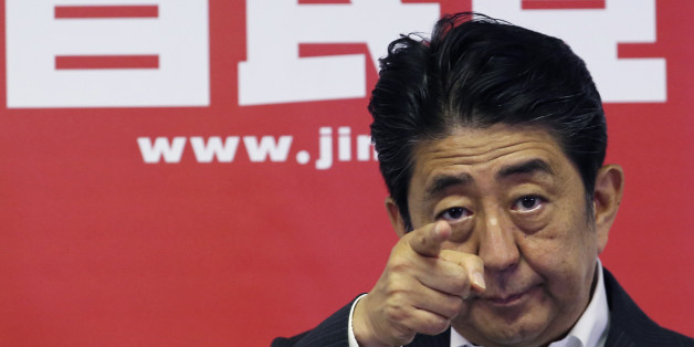 Japanese Prime Minister and leader of the ruling Liberal Democratic Party, Shinzo Abe, points a reporter for questions during a press conference in Tokyo, Monday, July 11, 2016. A resounding election victory for Abeâs ruling bloc has opened the door a crack for his long-cherished ambition to revise the constitution for the first time since it was enacted in 1947 - a behind-the-scenes agenda that could over time change Japanâs future. (AP Photo/Koji Sasahara)