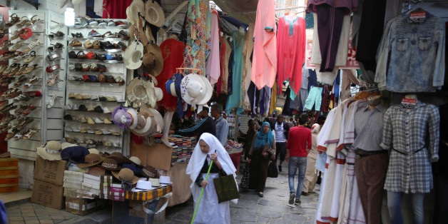 People walk past a clothes shop in Tunis, Tunisia, April 25, 2016. REUTERS/Zoubeir Souissi