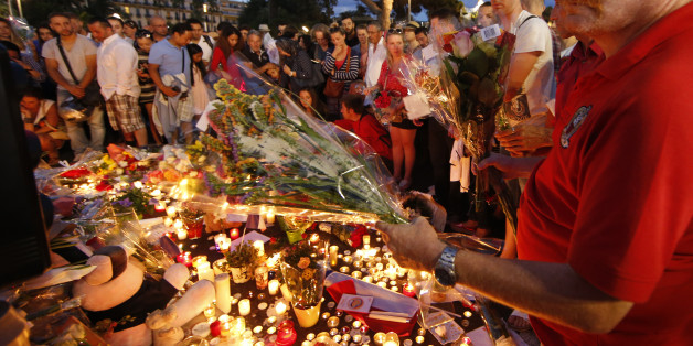 People gather to leave flowers in tribute to victims the day after a truck ran into a crowd at high speed killing scores and injuring more on the Promenade des Anglais who were celebrating the Bastille Day national holiday, in Nice, France, July 15, 2016. REUTERS/Eric Gaillard