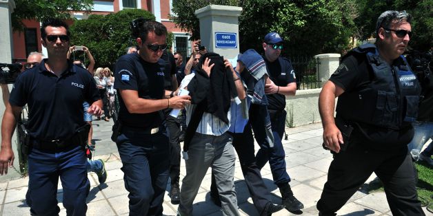 Turkish officers escorted by Greek police officers leave the courthouse of Alexandroupoli after appearing before a Greek prosecutor, on July 17, 2016. Eight Turkish military personnel who fled to Greece by helicopter after July 15 failed coup took no part in the putsch, their lawyer said, although a Greek government spokeswoman contradicted their account. The eight, who have claimed asylum in Greece, arrived by military helicopter on July 16, 2016 after sending a distress signal to authorities