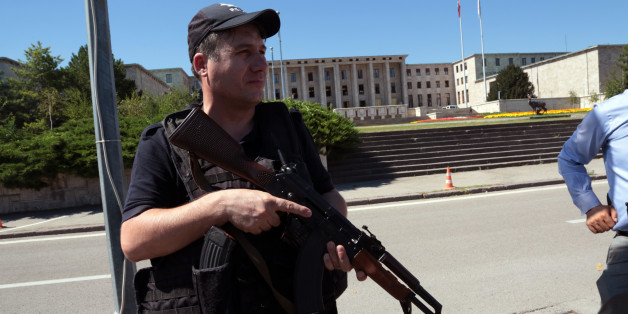 A police officer stands outside Turkey's parliament near the Turkish military headquarters in Ankara, Turkey, Saturday, July 16, 2016. Forces loyal to Turkey's President Recep Tayyip Erdogan quashed a coup attempt in a night of explosions, air battles and gunfire that left dozens dead Saturday. Authorities arrested thousands of people as President Recep Tayyip Erdogan vowed those responsible "will pay a heavy price for their treason." (AP Photo/Burhan Ozbilici)