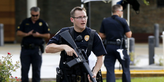 Police guard the emergency room entrance of Our Lady Of The Lake Medical Center, where wounded officers were brought, in Baton Rouge, La., Sunday, July 17, 2016. Multiple law enforcement officers were killed and wounded Sunday morning in a shooting near a gas station in Baton Rouge, less than two weeks after a black man was shot and killed by police here, sparking nightly protests across the city. (AP Photo/Gerald Herbert)