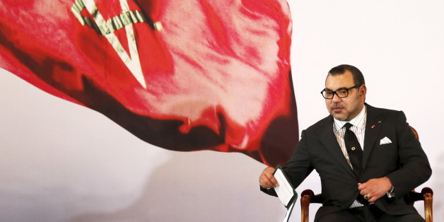Morocco's King Mohammed VI holds a book during a visit, at the presidential palace in Abidjan June 2, 2015. REUTERS/Thierry Gouegnon