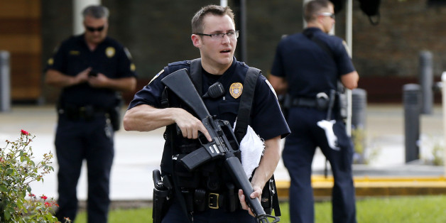 Police guard the emergency room entrance of Our Lady Of The Lake Medical Center, where wounded officers were brought, in Baton Rouge, La., Sunday, July 17, 2016. Multiple law enforcement officers were killed and wounded Sunday morning in a shooting near a gas station in Baton Rouge, less than two weeks after a black man was shot and killed by police here, sparking nightly protests across the city. (AP Photo/Gerald Herbert)