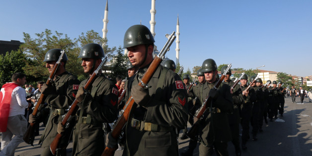 Turkish soldiers march after a mass funeral for the victims of a failed military coup last Friday, outside Kocatepe Mosque in Ankara, Turkey, Sunday, July 17, 2016. The Turkish government accelerated its crackdown on alleged plotters of the failed coup against President Recep Tayyip Erdogan, with the justice minister saying Sunday that 6,000 people had been detained in the investigation, including three of the country's top generals and hundreds of soldiers. (AP Photo/Burhan Ozbilici)