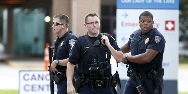 Police guard the emergency room entrance of Our Lady Of The Lake Medical Center, where wounded officers were brought, in Baton Rouge, La., Sunday, July 17, 2016. Multiple law enforcement officers were killed and wounded Sunday morning in a shooting near a gas station in Baton Rouge, less than two weeks after a black man was shot and killed by police here, sparking nightly protests across the city. (AP Photo/Gerald Herbert)