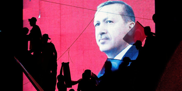 Turkish Supporters are silhouetted against a screan showing President Tayyip Erdogan during a pro-government demonstration in Ankara, Turkey, July 17, 2016. REUTERS/Baz Ratner