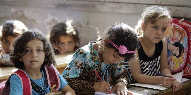 Girls attend a class at a school in southern countryside of Idlib, Syria, September 20, 2015. REUTERS/Khalil Ashawi
