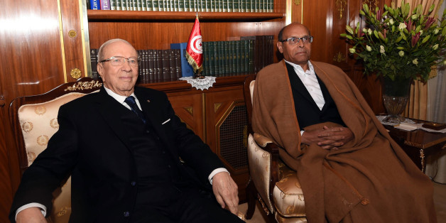 Tunisia's new President, Beji Caid Essebsi, left, poses in his office with out-going President, Moncef Marzouki, during a handover ceremony at the presidential palace in Carthahe outside Tunis, Tunisia, Wednesday, Dec. 31, 2014. Tunisia's new president pledged a rule of reconciliation and consensus as he took his oath Wednesday before the newly elected parliament to complete the country's democratic transition. The inauguration of Beji Caid Essebsi, an 88-year-old political veteran, comes in a year in which Tunisians wrote a new constitution and elected a new parliament and president, ending a transition kicked off by a revolution. (AP Photo)