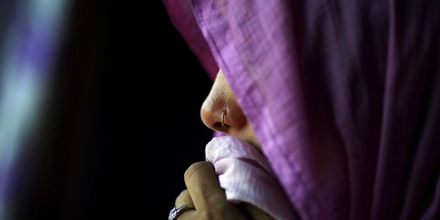 The stepmother of Meenakshi Kumari, 23, one of the two sisters allegedly threatened with rape by a village council in the northern Indian state of Uttar Pradesh, weeps inside her house at Sankrod village in Baghpat district, India, September 1, 2015. A village council in northern India has denied allegations that it ordered two young sisters to be raped because their brother eloped with a higher caste woman. The council's purported ruling led to an international outcry and hundreds of thousands of people have demanded their safety. Picture taken September 1, 2015. REUTERS/Adnan Abidi