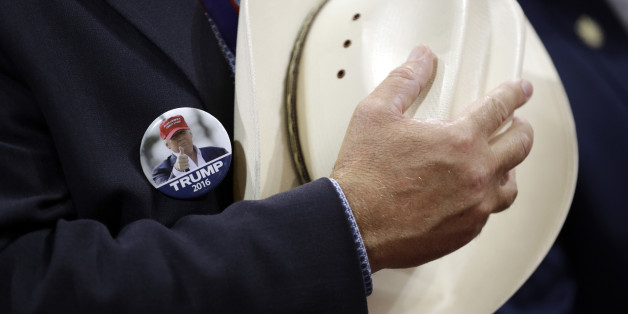 A Trump supporter holds a hat over his chest during as he sings the national anthem during first day of the Republican National Convention in Cleveland, Monday, July 18, 2016. (AP Photo/John Locher)
