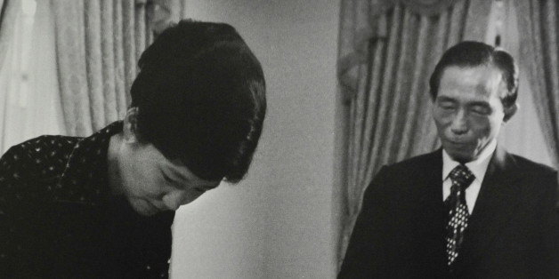 Park Geun-hye (L) uses a writing brush to write calligraphy as her father, the late South Korean President Park Chung-hee, looks on in Seoul in this August 31, 1977 picture which Reuters obtained August 27, 2012. Park Geun-hye was picked as the presidential candidate of the ruling conservative and right-wing Saenuri Party on August 20, 2012. Park is the daughter of former military dictator Park Chung-hee who took power in a military coup in 1961 and ruled until his assassination in 1979. Park's