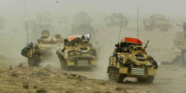 A British army armoured vehicle convoy rolls into southern Iraq March 22, 2003. Picture taken March 22, 2003. REUTERS/Oleg Popov/File Photo