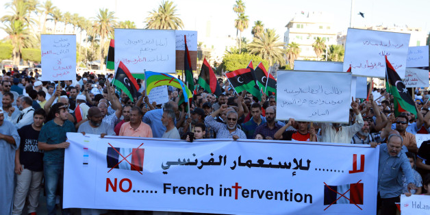 Libyan protesters hold banners and placards during a demonstration to protest against the French military intervention in the country on July 20, 2016 on Martyrs' Square in the capital Tripoli.Three French soldiers were killed during a mission to gather intelligence in Libya, President Francois Hollande said in the first official confirmation that France has troops in the country where IS controls a key city. / AFP / STRINGER (Photo credit should read STRINGER/AFP/Getty Images)