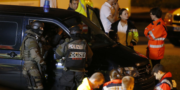 Special force police officers stand in front of a car near the Olympia shopping mall, following a shooting rampage at the mall in Munich, Germany July 23, 2016. REUTERS/Michael Dalder