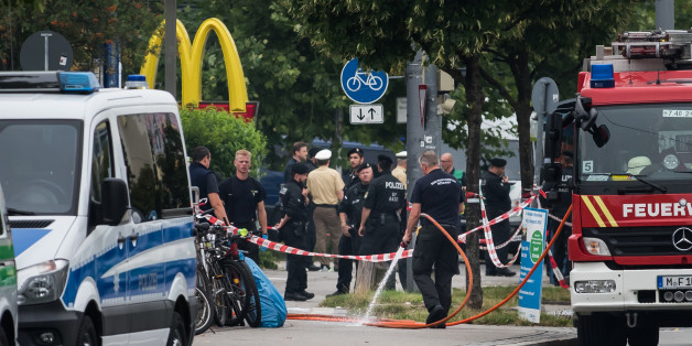MUNICH, GERMANY - JULY 23: Police and fire services clean the area the shooting occured outside the OEZ shopping center, the day after a shooting spree left nine victims dead on July 23, 2016 in Munich, Germany. According to police an 18-year-old German man of Iranian descent shot nine people dead and wounded at least 16 before he shot himself in a nearby park. For hours during the spree and the following manhunt the city lay paralyzed as police ordered people to stay off the streets. Original r