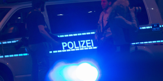 Policemen block the scene of a shooting with a large section of the surrounding area in Munich, Germany, Saturday, July 23, 2016. An 18-year-old German-Iranian man opened fire in a crowded Munich shopping mall and a nearby McDonald's Friday night, killing several people and wounding more than a dozen people before killing himself, the chief of police in the Bavarian capital said. (AP Photo/Jens Meyer)