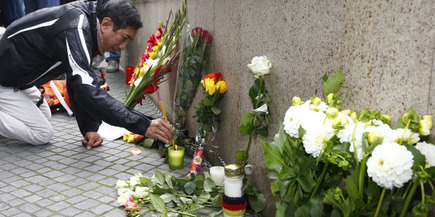 A man lights incense sticks near the Olympia shopping mall, where yesterday's shooting rampage started, in Munich, Germany July 23, 2016. REUTERS/Arnd Wiegmann