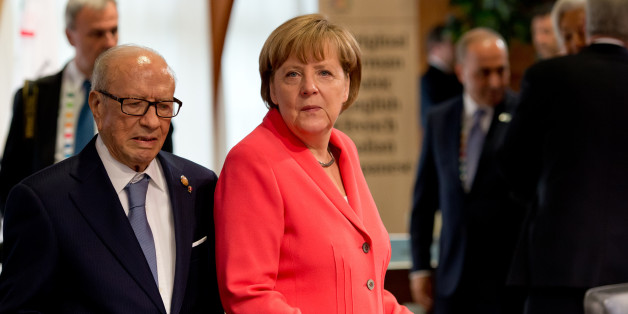 German chancellor Angela Merkel , right, and Tunisia's President Beji Caid Essebsi. wait prior to a working session at the G-7 summit at Schloss Elmau hotel near Garmisch-Partenkirchen, southern Germany, Monday June 8, 2015. (Sven Hoppe/Pool Photo via AP)