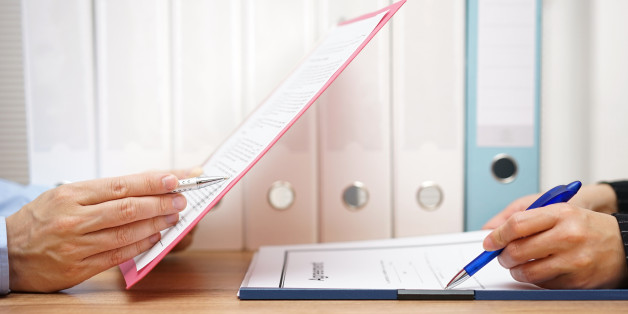 Inspector and auditor are inspecting legal and financial documents