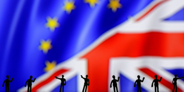 Miniature models of people are pictured in front of the European Union and UK flags in this photo illustration taken June 21, 2016. REUTERS/Dado Ruvic/Illustration TPX IMAGES OF THE DAY