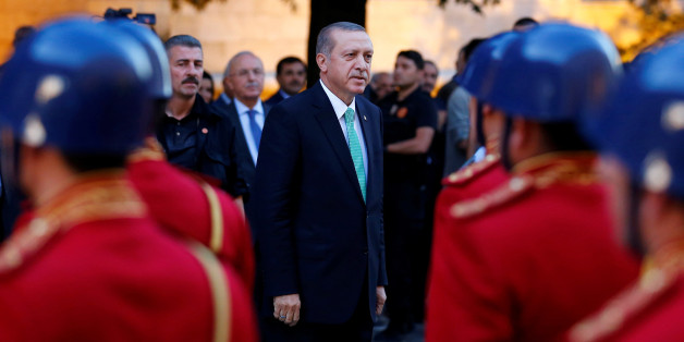 Turkish President Tayyip Erdogan reviews a guard of honour as he arrives to the Turkish Parliament in Ankara, Turkey, July 22, 2016. REUTERS/Umit Bektas