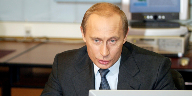 Russian President Vladimir Putin sits at a desktop computer in Moscow's Kremlin, January 19, 2004. Putin on Monday attended the presentation of the presidential web-site called "President of Russia to school-age citizens". REUTERS/Alexander Natruskin CVI/JV