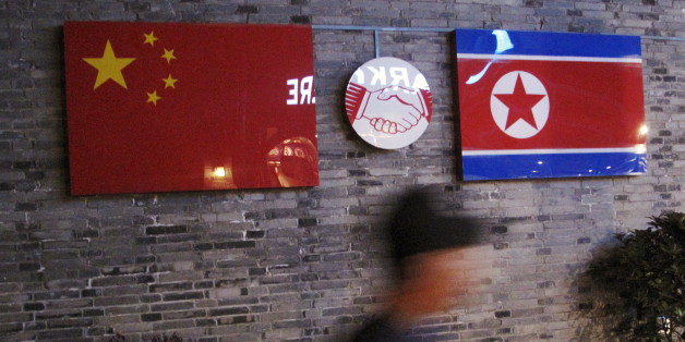 Flags of China and North Korea are seen outside the closed Ryugyong Korean Restaurant in Ningbo, Zhejiang province, China, April 12, 2016. REUTERS/Joseph Campbell