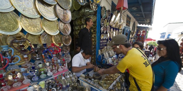 Tourists look at the stall of a street vendor in Sidi Bou Said on October 19, 2011, days before a historic national election in Tunisia. Arab states that were once transfixed by the January revolt in Tunisia are now more focused on their internal crises than the historic October 23 elections in the tiny north African state. Tunisians are to elect members of an assembly that will write a new constitution for the country, nine months after strongman Zine el Abidine Ben Ali was ousted in protests that spread to countries across the region. AFP PHOTO / LIONEL BONAVENTURE (Photo credit should read LIONEL BONAVENTURE/AFP/Getty Images)