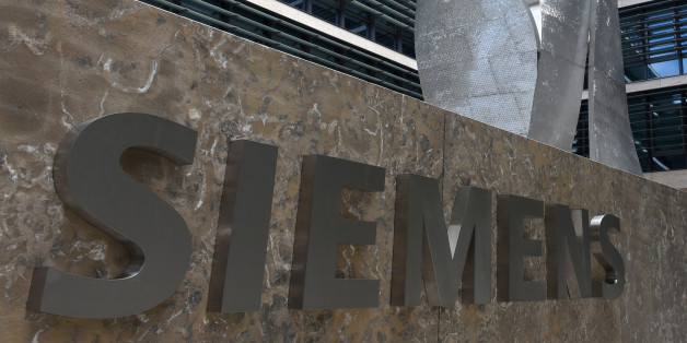 German engineering giant Siemens' logo is pictured in front of the main entrance of the new headquarters in Munich, southern Germany, on June 14, 2016.
The new building designed and built in the past six years, will provide jobs for 1,200 employees and will be officially opened at the end of June 2016. / AFP / CHRISTOF STACHE (Photo credit should read CHRISTOF STACHE/AFP/Getty Images)