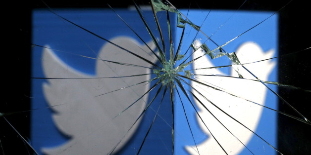 A 3D-printed Twitter logo is seen through broken glass, in this picture illustration taken February 8, 2016. Twitter shed 5.4 percent to hit a new record low of $14.87 after reports over the weekend that the company was planning to change how it display tweets. REUTERS/Dado Ruvic/Illustration