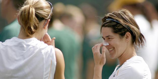 Australia's forward Sarah Walsh (R) chats with her teammate Dianne Alagich (R) while using sunblock before a training session in Chengdu, in China's southwestern province of Sichuan, 17 September 2007. Australia will face Canada in a Group C match of the FIFA Women's Football World Cup on 19 September in Chengdu. AFP PHOTO/LIU Jin (Photo credit should read LIU JIN/AFP/Getty Images)