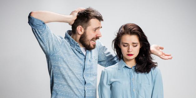 The young couple with different emotions during conflict on gray background