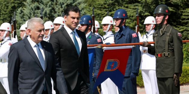 Turkey's Prime Minister Binali Yildirim (L) and Turkish Republic of Northern Cyprus (TRNC) Prime Minister Huseyin Ozgurgun inspect an honor guard during an official welcoming ceremony at the Cankaya Palace in Ankara on July 26, 2016. The UN said on July 21 it was concerned that the failed coup attempt in Turkey could dampen prospects for Cyprus' peace process aimed at reunifying the divided Mediterranean island. / AFP / ADEM ALTAN (Photo credit should read ADEM ALTAN/AFP/Getty Images)