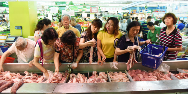 Customers select meat at a supermarket in Hangzhou, Zhejiang province, China, June 9, 2016. REUTERS/Stringer ATTENTION EDITORS - THIS PICTURE WAS PROVIDED BY A THIRD PARTY. EDITORIAL USE ONLY. CHINA OUT. NO COMMERCIAL OR EDITORIAL SALES IN CHINA.