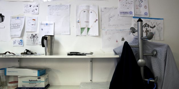 Children's drawings are posted on the wall of the dentist's office at the Doctors of the World polyclinic in central Athens, Greece, October 27, 2015. Picture taken October 27, 2015. To match Special Report GREECE-TEETH/ REUTERS/Alkis Konstantinidis