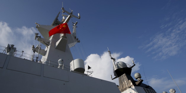 A Chinese People's Liberation Army (PLA) navy personnel looks out of their Jiangkai II class vessel, CNS Yulin, during a display of warships ahead of the IMDEX Asia maritime defence exhibition at Changi Naval Base in Singapore May 18, 2015. The 10th international maritime defence show which sees participation from 180 exhibitors and delegations from over 40 countries takes place from May 19 to 21. REUTERS/Edgar Su