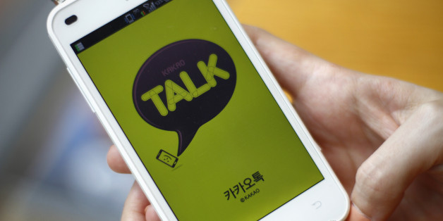In this Aug. 20, 2012 photo, a woman opens Kakao Talk, a South Korean mobile messaging app with more than 60 million users, on her smartphone in Seoul, South Korea. A handful of smartphone apps that began as basic instant messaging services have amassed several hundred million users in Asia in just a couple of years, mounting a challenge to the popularity of online hangouts such as Facebook as they branch into games, e-commerce, celebrity news and other areas. (AP Photo/Hye Soo Nah)