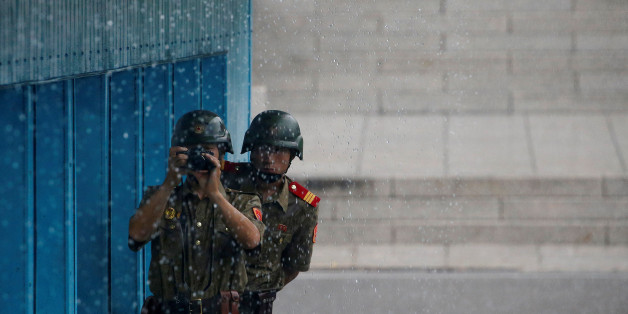 North Korean soldiers keeps watch toward the south as it rains during a ceremony marking the 63rd anniversary of the signing of the Korean War ceasefire armistice agreement at the truce village of Panmunjom, South Korea, July 27, 2016. REUTERS/Kim Hong-Ji