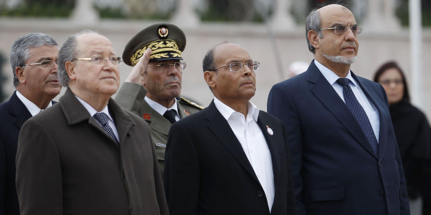 Tunisian Prime Minister Hamadi Jebali (R), President Moncef Marzouki (front C) and President of the Constituent Assembly Mustapha Ben Jaafar (front L) listen to playing of the national anthem during a ceremony marking the second year anniversary of the revolution in Tunis January 14, 2013. REUTERS/Zoubeir Souissi (TUNISIA - Tags: POLITICS ANNIVERSARY)