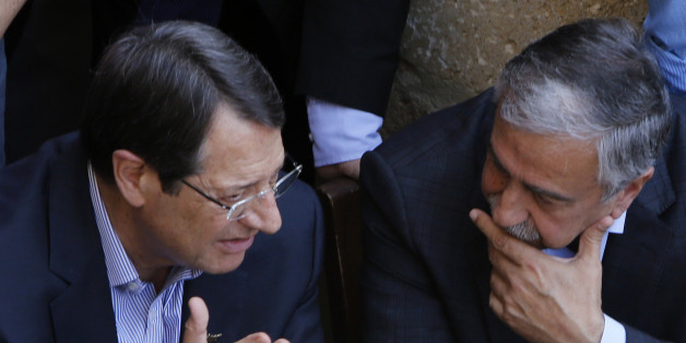 Cyprus President Nicos Anastasiades, left, and Turkish Cypriot leader Mustafa Akinci, speak as they sit at a coffee shop at the Turkish Cypriot breakaway northern part of the Cypriot divided capital Nicosia on Saturday, May 23, 2015. Cyprusâ rival Greek and Turkish Cypriot leaders took a stroll together on both sides of the divided capitalâs medieval center to raise the feel-good factor as talks aimed at reunifying the ethnically split island kick into gear. Itâs the first time that the leaders have done so together since the east Mediterranean island was split in 1974 when Turkey invaded after coup by supporters of union with Greece. (AP Photo/Petros Karadjias)