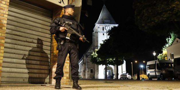 French riot police guards the street to access the church where an hostage taking left a priest dead in Saint-Etienne-du-Rouvray, Normandy, France, Tuesday, July 26, 2016. Two attackers invaded a church Tuesday during morning Mass near the Normandy city of Rouen, killing an 84-year-old priest by slitting his throat and taking hostages before being shot and killed by police, French officials said. (AP Photo/Francois Mori)