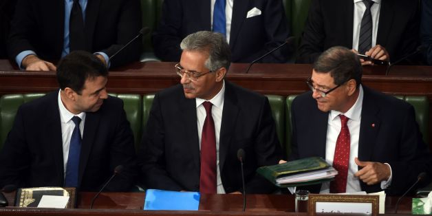Tunisian Prime Minister Habib Essid (R) talks with newly-appointed Justice Minister Amor Mansour (C) and Interior Minister Hedi Majdoub on January 11, 2016 during a session at the assembly of the representatives of the people (ARP) in Tunis before a confidence vote to approve the new government.
Essid announced a major cabinet reshuffle on January 6, 2016 as his government grapples with a growing jihadist threat and a feeble economy.
/ AFP / FETHI BELAID (Photo credit should read FETHI BELAID/AFP/Getty Images)