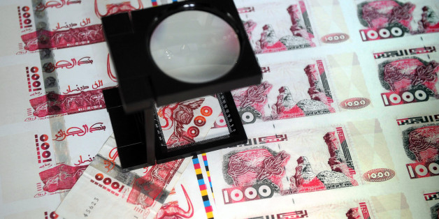 A picture taken on October 26, 2009 in Lyon, central France shows plates of false printed Algerian Dinar banknotes, shown during a press conference given after the police broke up a network of counterfeit currency. Twelve people were jailed and indicted on October 25, but the network has already used at least 200,000 banknotes of 1,000 dinars, or nearly 2 million Euros, said judicial police. AFP PHOTO PHILIPPE MERLE (Photo credit should read PHILIPPE MERLE/AFP/Getty Images)