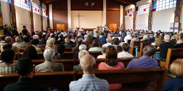 People attend a mass in tribute to priest Jacques Hamel in the Sainte-Therese church on July 30, 2016 in Saint-Etienne-du-Rouvray.
Muslim and Christian groups will hold vigils on July 30, 2016, for a French priest murdered by jihadists in his church, as police charged a man in connection with the brutal attack that has plunged the nation into mourning again. Father Jacques Hamel had his throat slit on the altar by IS-inspired attackers who stormed his church in a Normandy town during mass Tuesday.
/ AFP / CHARLY TRIBALLEAU (Photo credit should read CHARLY TRIBALLEAU/AFP/Getty Images)