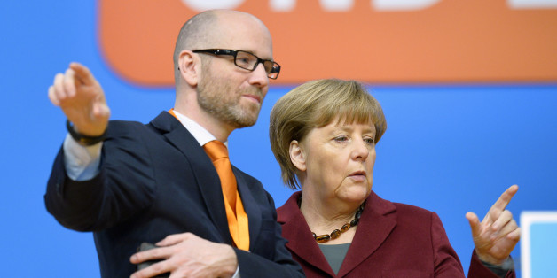 German Chancellor and Christian Democratic Union (CDU) leader Angela Merkel (R) and Peter Tauber, secretary general of the party, inspect the location for the CDU's party congress in Karlsruhe, southwestern Germany, on December 13, 2015. German Chancellor Angela Merkel will seek at her party's congress to stamp out dissent in her conservative Christian Democratic Union over a record refugee influx after months of corrosive infighting. AFP PHOTO / THOMAS KIENZLE / AFP / THOMAS KIENZLE (Ph