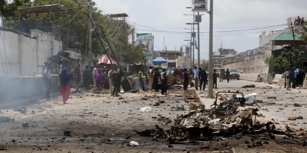 MOGADISHU, SOMALIA - JULY 31 : Wreckage of a car is seen at the scene of a suicide attack outside Criminal Investigation Department (CID) headquarters in the capital Mogadishu, Somalia, 31 July 2016. (Photo by Nour Gelle Gedi/Anadolu Agency/Getty Images)